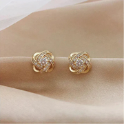 Brincos dourados em espiral floral com cristais