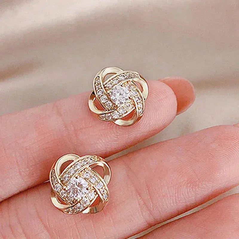 Brincos dourados em espiral floral com cristais